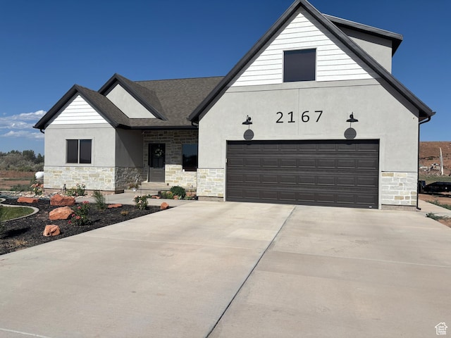2167 S 560 W, Roosevelt, UT 84066 - view of front of property with stone siding, stucco siding, driveway, and a garage