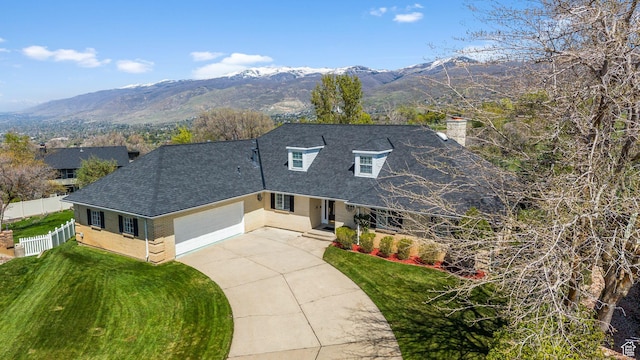 view of front of property featuring a chimney, fence, a shingled roof, concrete driveway, and an attached garage