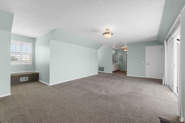 unfurnished living room with baseboards, carpet flooring, and visible vents
