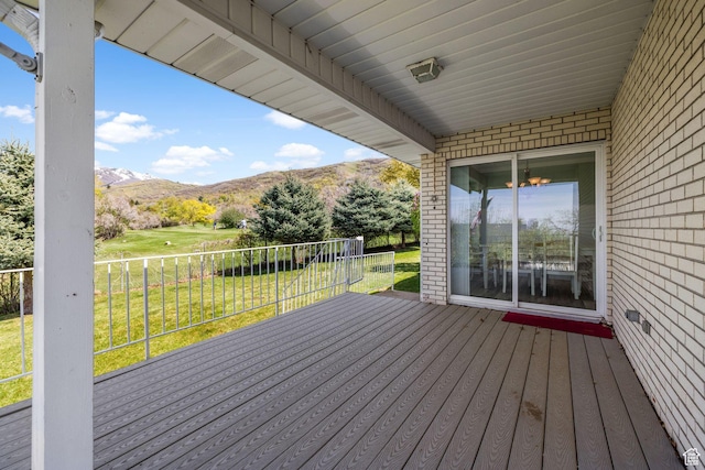deck featuring a yard and a mountain view