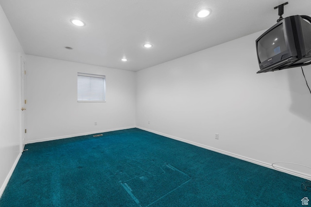 carpeted empty room with baseboards and recessed lighting