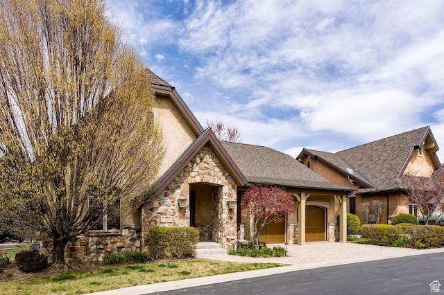 3143 E Bavarian Ct, Cottonwood Heights, UT 84093 - view of front of property featuring stone siding, an attached garage, driveway, and stucco siding
