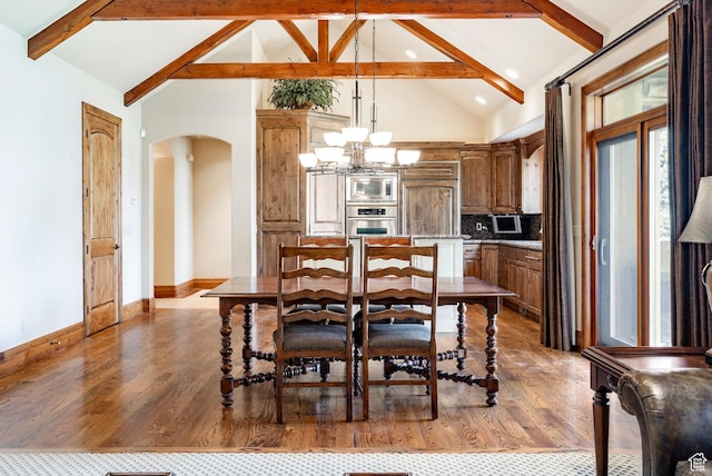 3143 E Bavarian Ct, Cottonwood Heights, UT 84093 - dining room with beam ceiling, wood finished floors, and arched walkways