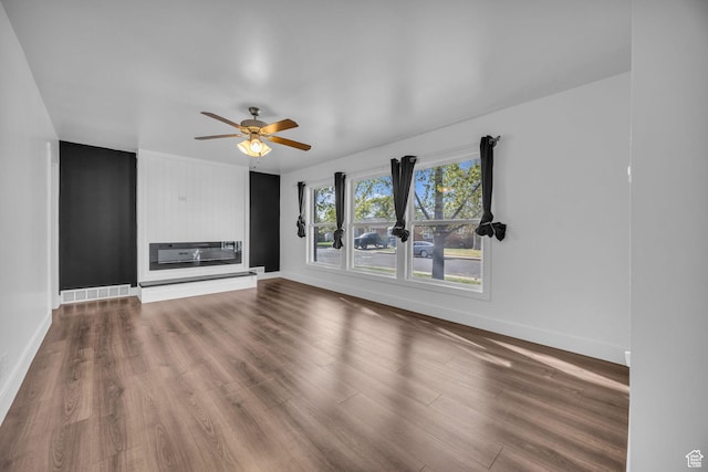 181 E 4300 S, Washington Terrace, UT 84405 - unfurnished living room with a glass covered fireplace, baseboards, visible vents, a ceiling fan, and wood finished floors