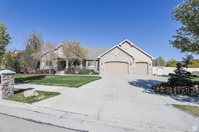 view of front facade with concrete driveway, a front lawn, stone siding, an attached garage, and fence