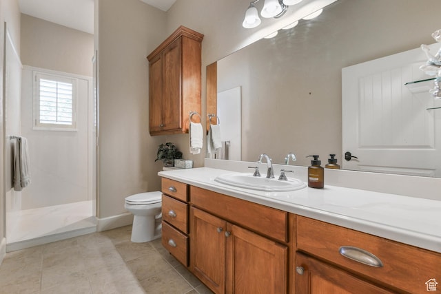 full bathroom featuring vanity, tile patterned flooring, a walk in shower, and toilet