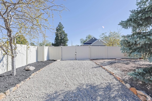 view of yard featuring fence and a gate