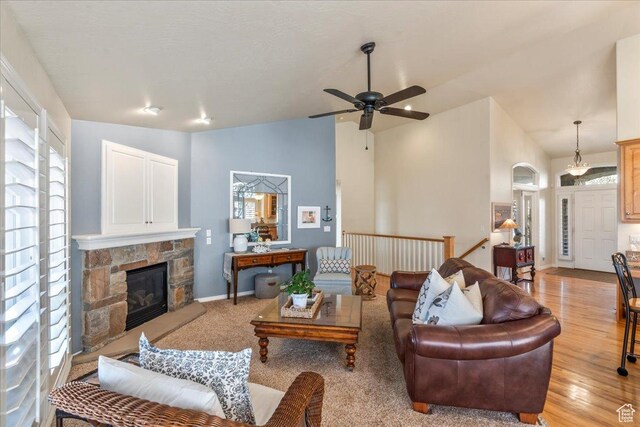 2010 E Rocklin Dr, Sandy, UT 84092 - living room with ceiling fan, baseboards, light wood-style flooring, a fireplace, and lofted ceiling