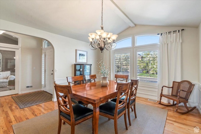 2010 E Rocklin Dr, Sandy, UT 84092 - dining space with light wood finished floors, lofted ceiling with beams, visible vents, and arched walkways