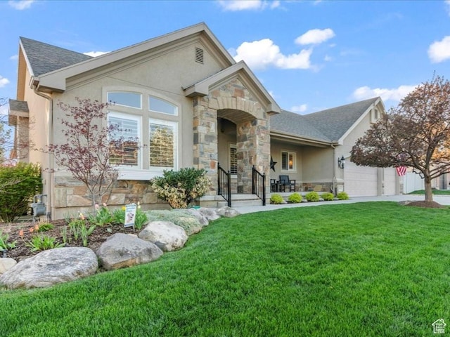 ranch-style home with an attached garage, stone siding, a front lawn, and stucco siding