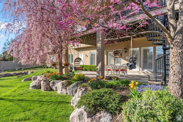 2010 E Rocklin Dr, Sandy, UT 84092 - rear view of house featuring a patio area, a yard, and stucco siding