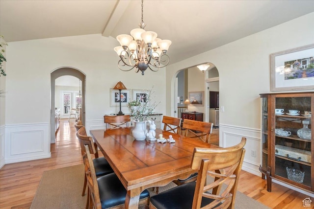 2010 E Rocklin Dr, Sandy, UT 84092 - dining room with arched walkways, light wood-style flooring, a notable chandelier, and wainscoting