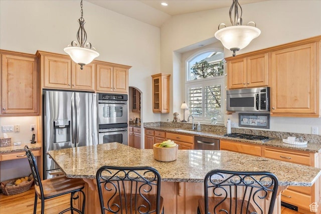 2010 E Rocklin Dr, Sandy, UT 84092 - kitchen with a kitchen breakfast bar, a sink, light stone countertops, appliances with stainless steel finishes, and high vaulted ceiling
