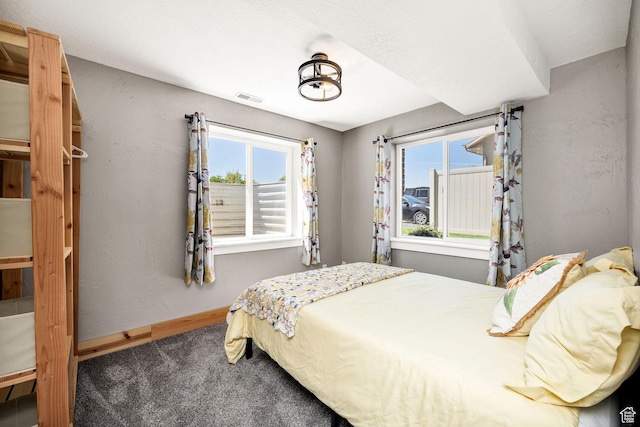 bedroom featuring baseboards, visible vents, and carpet floors