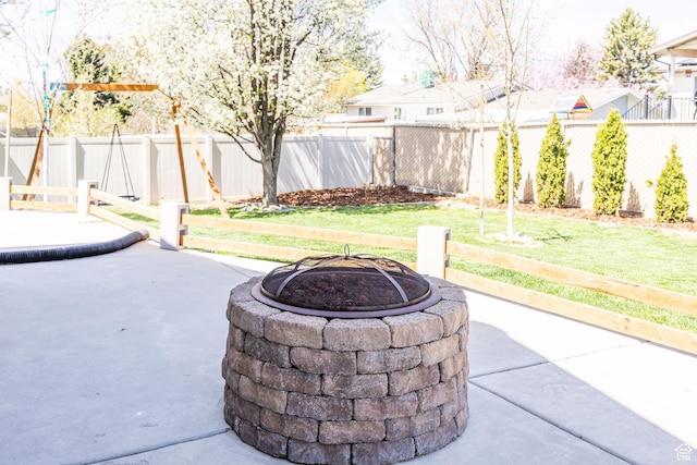 view of patio featuring a fenced backyard and an outdoor fire pit