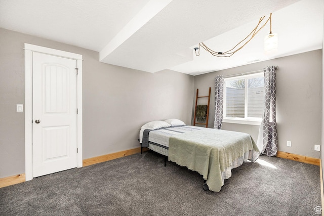 carpeted bedroom featuring baseboards