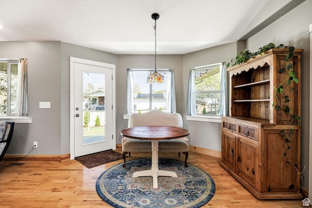 dining room with light wood-style flooring and baseboards