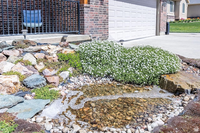 details featuring brick siding and concrete driveway