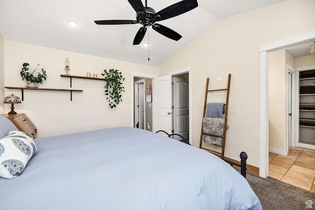 bedroom featuring vaulted ceiling, baseboards, light colored carpet, ceiling fan, and light tile patterned floors