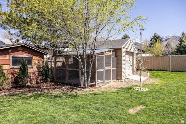 exterior space featuring fence and a lawn