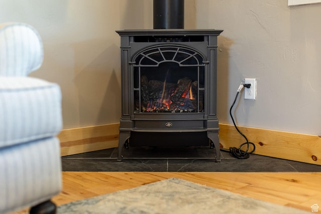 details featuring wood finished floors and a wood stove