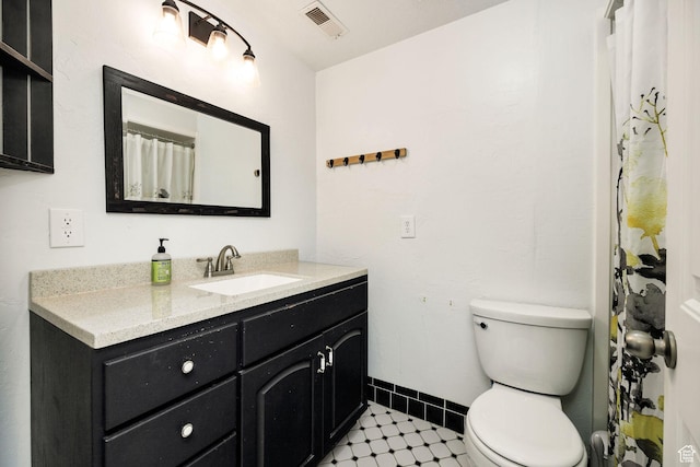 bathroom with baseboards, visible vents, toilet, and vanity