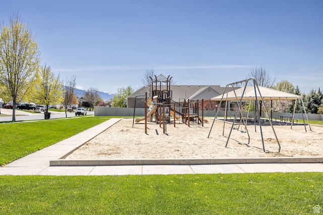 community playground featuring a lawn and a mountain view