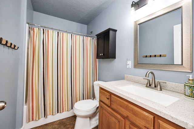 bathroom featuring tile patterned flooring, a textured ceiling, toilet, and vanity