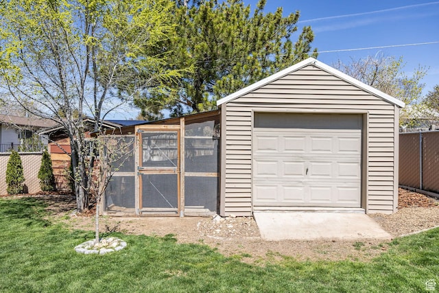 detached garage featuring fence