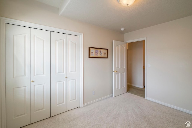 618 W 225 S, Layton, UT 84041 - unfurnished bedroom with baseboards, a textured ceiling, carpet floors, and a closet