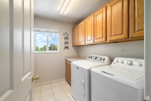 618 W 225 S, Layton, UT 84041 - clothes washing area featuring washer and clothes dryer, light tile patterned flooring, baseboards, cabinet space, and a textured ceiling