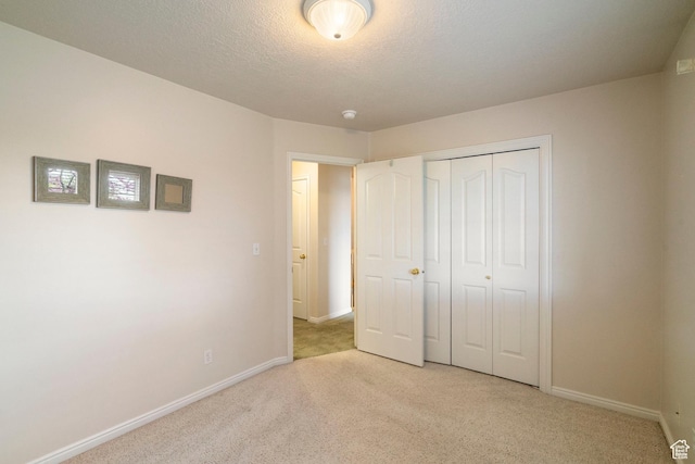 618 W 225 S, Layton, UT 84041 - unfurnished bedroom featuring light colored carpet, baseboards, a textured ceiling, and a closet