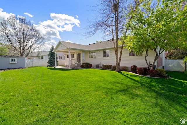 618 W 225 S, Layton, UT 84041 - rear view of property with fence, an outbuilding, a yard, and a patio