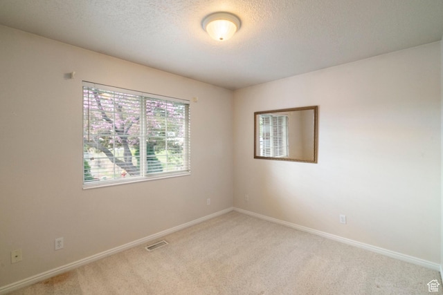 618 W 225 S, Layton, UT 84041 - unfurnished room featuring a textured ceiling, baseboards, visible vents, and light colored carpet