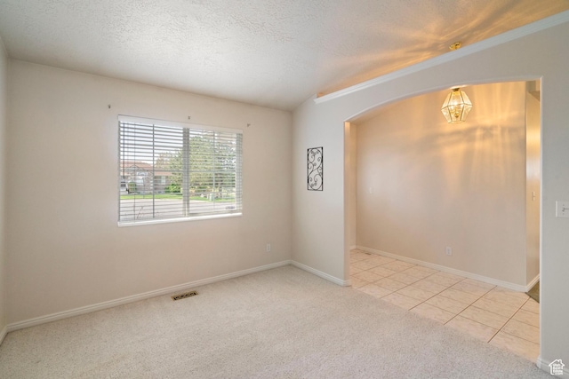 618 W 225 S, Layton, UT 84041 - spare room with an inviting chandelier, visible vents, light carpet, arched walkways, and a textured ceiling