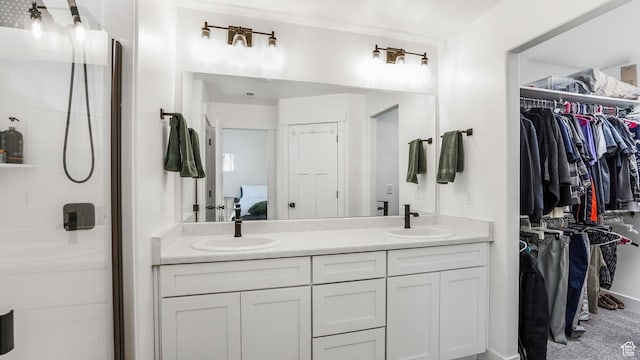 12373 S Pedroia St, Herriman, UT 84096 - ensuite bathroom featuring double vanity, a walk in closet, and walk in shower