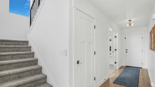 12373 S Pedroia St, Herriman, UT 84096 - foyer entrance featuring stairs, wood finished floors, and baseboards