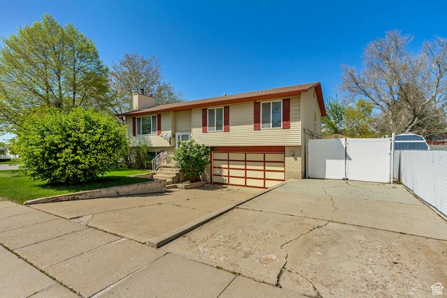 386 W 1125 N, Centerville, UT 84014 - raised ranch with a chimney, a gate, concrete driveway, brick siding, and a garage