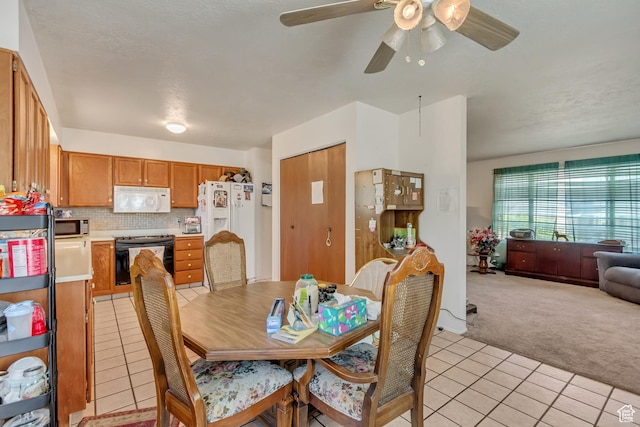 386 W 1125 N, Centerville, UT 84014 - dining area featuring light tile patterned flooring, ceiling fan, and light carpet