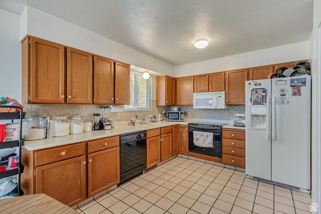 386 W 1125 N, Centerville, UT 84014 - kitchen with a sink, backsplash, brown cabinetry, light countertops, and black appliances