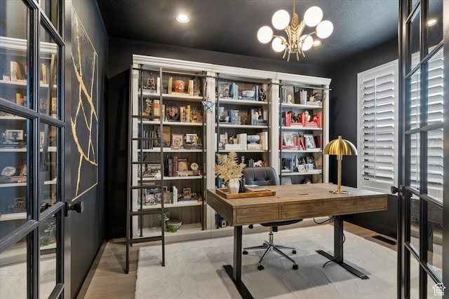 office area with a chandelier and wood finished floors