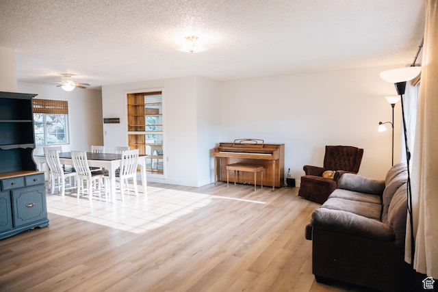 109 S 2nd W, Grace, ID 83241 - living area featuring a ceiling fan, baseboards, a textured ceiling, and light wood-style floors