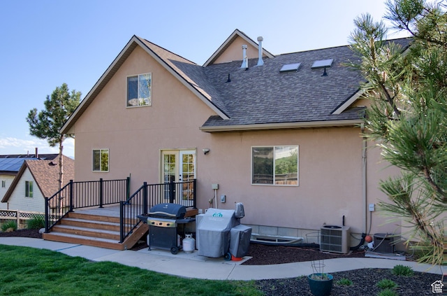 1896 N Main St, Orem, UT 84057 - back of house featuring roof with shingles, central AC unit, stucco siding, and a deck