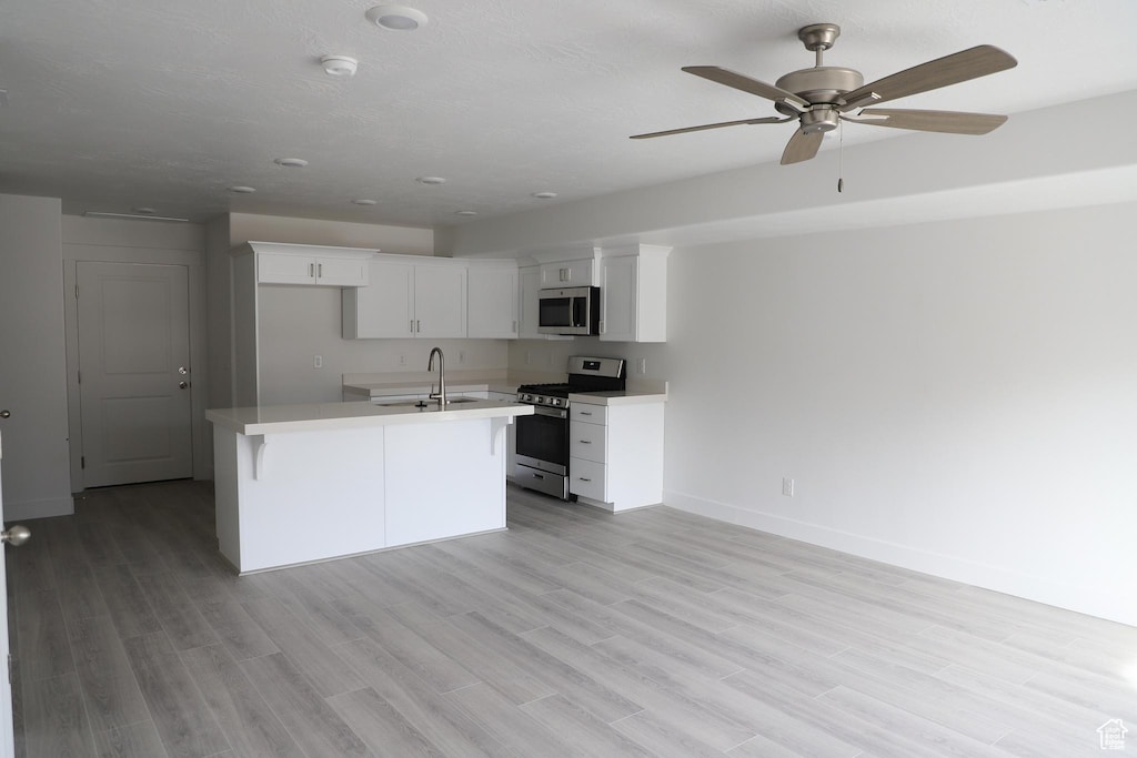 1378 N 1810 E, Spanish Fork, UT 84660 - kitchen with appliances with stainless steel finishes, light countertops, white cabinets, ceiling fan, and baseboards