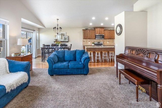 4206 Rose Springs Rd, Erda, UT 84074 - living room featuring recessed lighting, vaulted ceiling, a chandelier, and light colored carpet