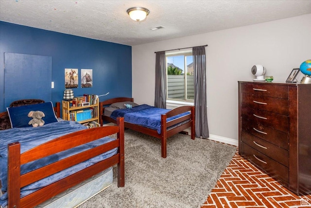 4206 Rose Springs Rd, Erda, UT 84074 - bedroom featuring a textured ceiling, baseboards, and brick patterned floors