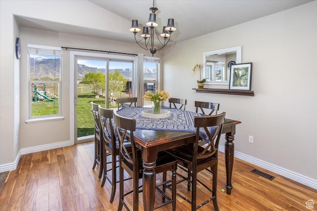 4206 Rose Springs Rd, Erda, UT 84074 - dining room with a chandelier, light wood-style floors, baseboards, and lofted ceiling