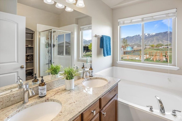 4206 Rose Springs Rd, Erda, UT 84074 - full bathroom with a mountain view, a shower stall, a bath, and double vanity