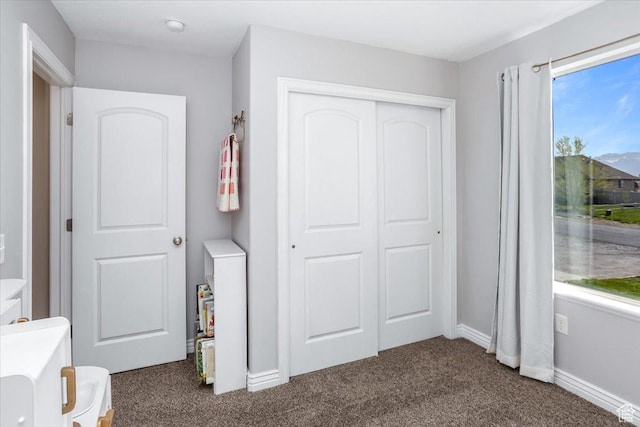 4206 Rose Springs Rd, Erda, UT 84074 - bedroom with dark carpet, a closet, and baseboards