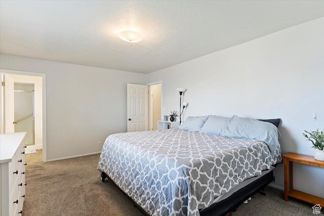 bedroom with baseboards, a textured ceiling, and carpet